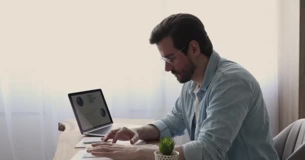 Jovem empresário stressado a calcular as despesas de projecto no cargo. — Vídeo de Stock