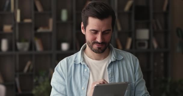 Glad ung drømmende mand ved hjælp af digital computer tablet. – Stock-video