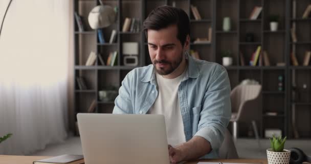 Glückliche junge männliche Unternehmer arbeiten am Computer zu Hause im Büro. — Stockvideo