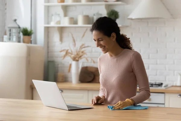 Young woman resting from chores having fun looking on pc