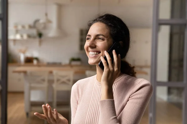 Overjoyed millennial latina female relax at home talk on phone — Stock Photo, Image