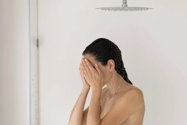Close up beautiful woman standing under shower in bathroom — Stock Photo, Image