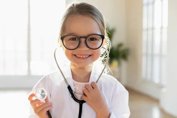 Portrait of small little girl play doctor game