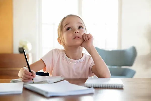 Dreamy little girl feel unmotivated studying alone — Stock Photo, Image