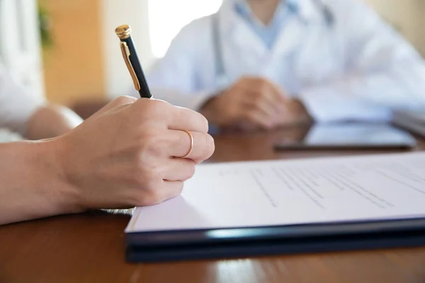 Close up of female patient close agreement with doctor — Stock Photo, Image