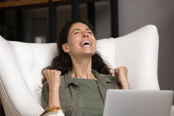 Close up overjoyed woman excited by good news, using laptop
