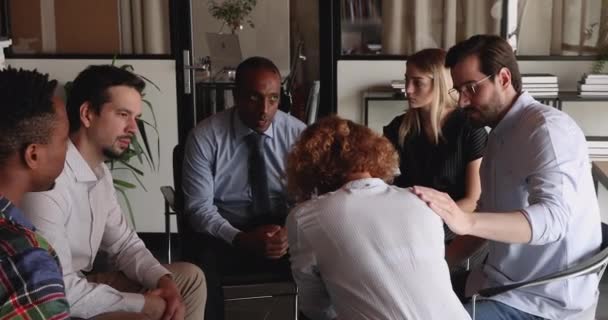 Stressed unhappy young woman sharing problems with compassionate colleagues. — Stock Video