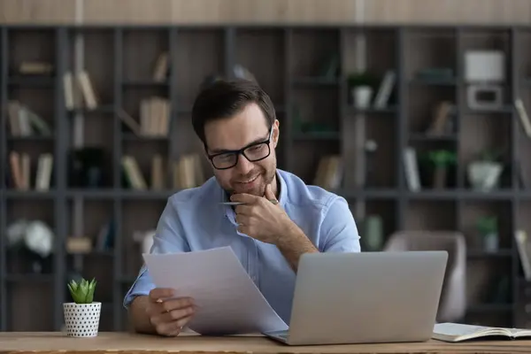 Smiling male employee read good news in paper contract — Stock Photo, Image