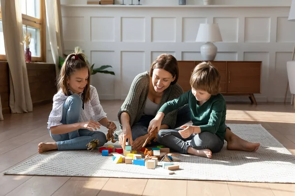 Happy mom and small kids play at home together — Stock Photo, Image