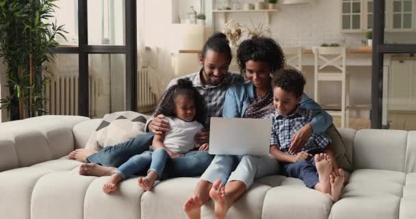 Relaxed bonding african american family using computer at home. — Stock Video