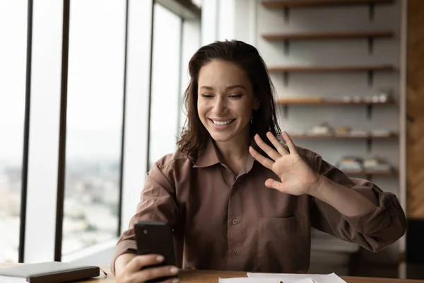 Smiling woman talk on webcam video call on cellphone