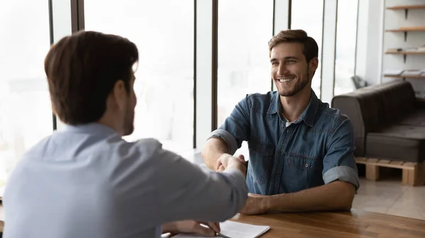 Smiling businessmen handshake at negotiations in office — Stock Photo, Image