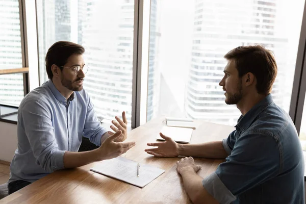 Caucasian male employer talk with colleague in office — Stock Photo, Image