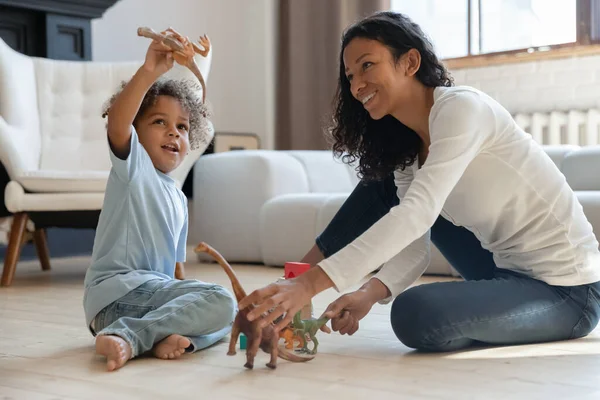 Glad söt pojke och hans mamma koppla av på golvet — Stockfoto