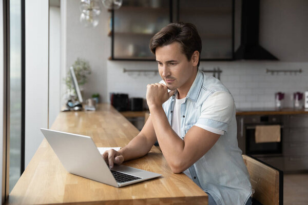 Caucasian man work on laptop in office thinking