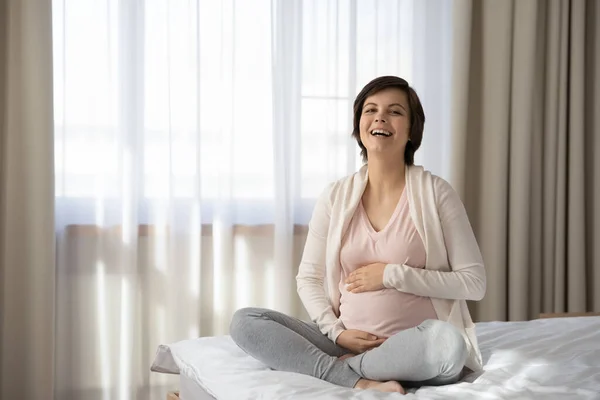Portrait of overjoyed pregnant woman caress baby bump — Stock Photo, Image
