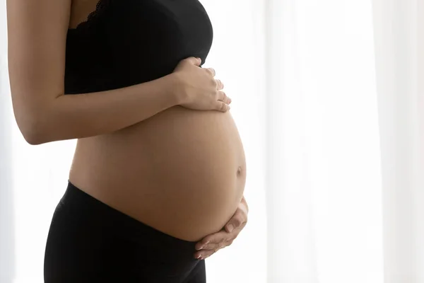 Close up of pregnant woman touch baby bump — Stock Photo, Image