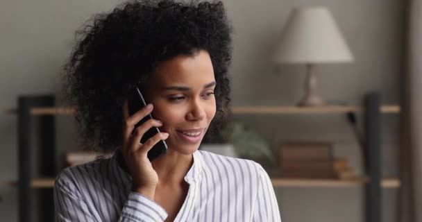 Pleased attractive African woman enjoy conversation on phone — Stock Video