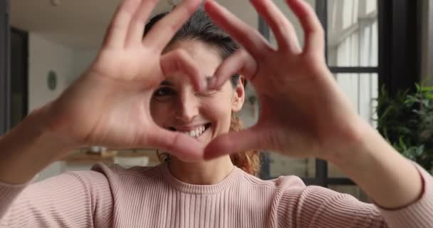 Счастливая женщина делает с пальцами форма сердца дает вам любовь — стоковое видео