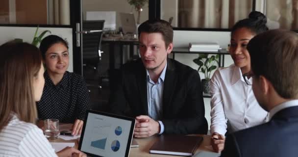 Feliz joven empresario discutiendo temas de proyecto con colegas multirraciales. — Vídeo de stock