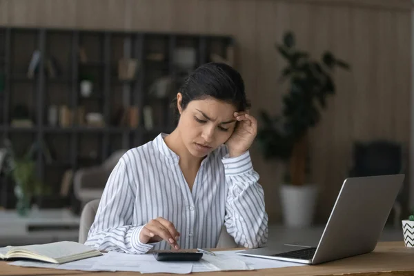 Unhappy Indian woman checking domestic bills at home, using calculator — Stock Photo, Image