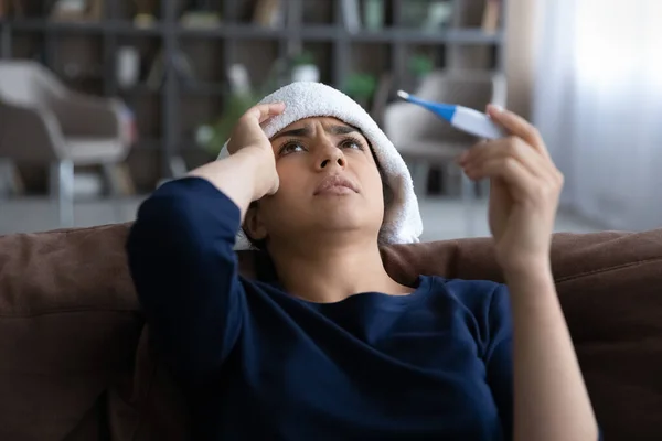 Close up sick Indian woman feeling unhealthy, holding thermometer — Stock Photo, Image