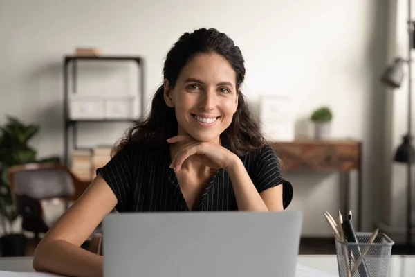 Confident young latin female posing by office computer at desk — Stock Photo, Image