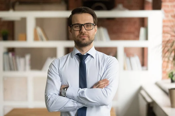 Head shot portrait confident businessman in glasses standing in office — Stock Photo, Image