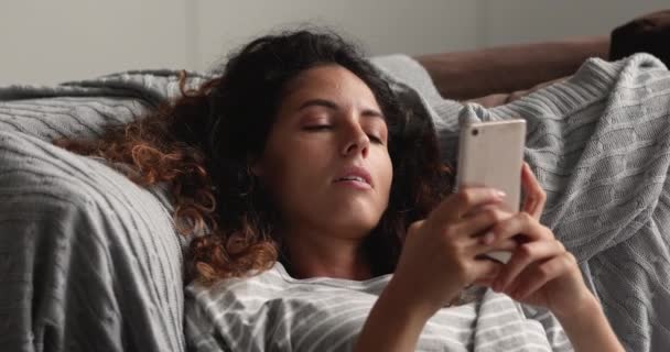 Addicted to technology young relaxed woman using smartphone. — Stock Video