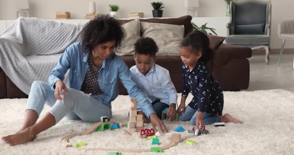 Jonge vrouw speelt thuis met kleine zoon en dochter — Stockvideo