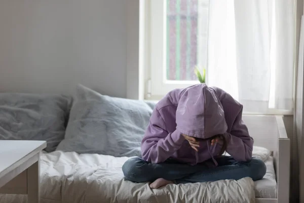 Unhappy adolescent kid daughter feeling depressed alone at home.