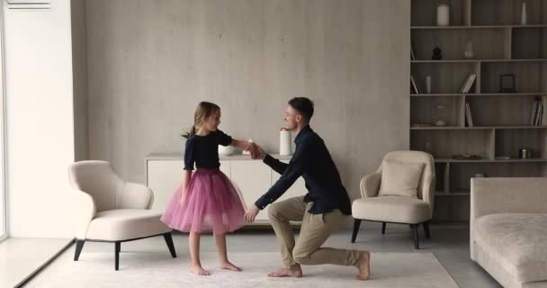 Loving father kiss arm invites to dance his little daughter — Stock Video