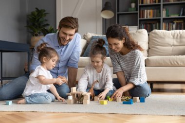 Sevgi dolu ebeveynler evde küçük kızlarıyla oynarlar.