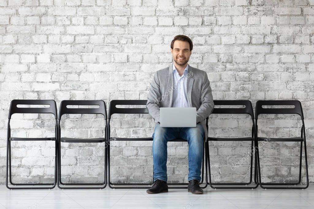 Applicant using laptop, searching vacancy on internet