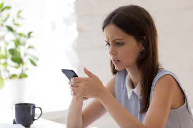 Hücredeki kötü mesajdan hayal kırıklığına uğramış mutsuz genç bir kadın.