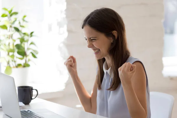 Opgewonden jonge vrouw triomf met goed nieuws op laptop — Stockfoto