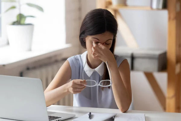 Tired millennial female suffer from dizziness in office — Stock Photo, Image