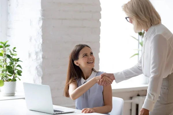 Smiling diverse female colleagues handshake in office — Stock Photo, Image