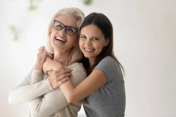 Portrait of happy mature mom and adult daughter hugging — Stock Photo, Image