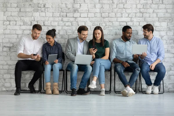 Diverse couples of millennial gadget users sharing content on tablet — Stock Photo, Image