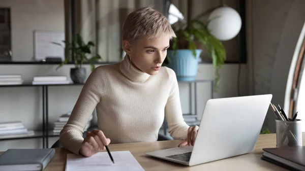 Businesswoman work online on laptop with paperwork — Stock Photo, Image