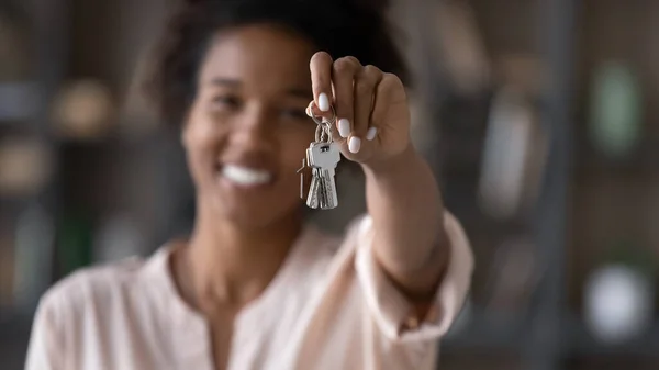 Close up focus on keys in female african ethnicity hands.