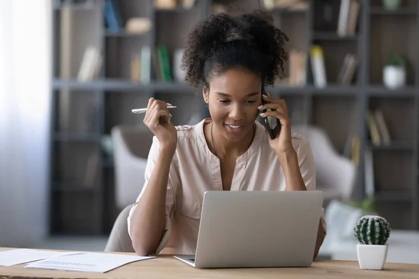 Smiling beautiful millennial african businesswoman multitasking in office. — Stock Photo, Image
