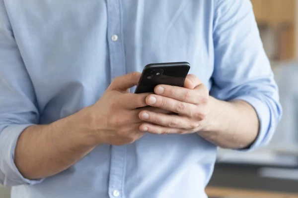 Close up businessman holding smartphone, typing on screen, browsing apps — Stock Photo, Image