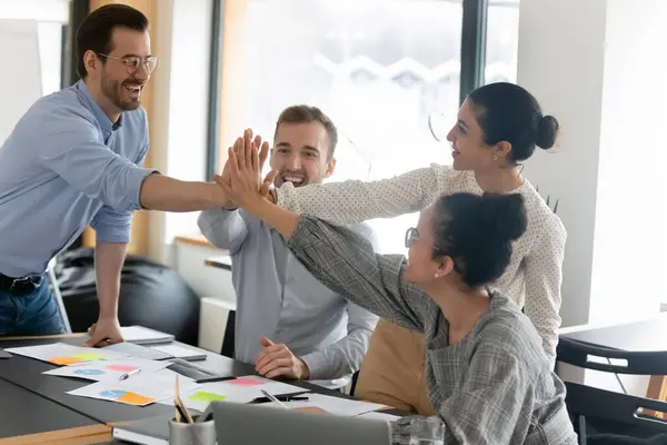 Excited diverse colleagues giving high five at meeting, celebrating success — Stock Photo, Image
