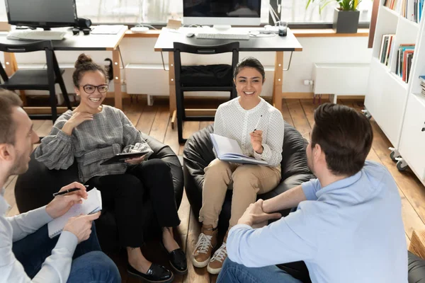 Overjoyed diverse colleagues employees chatting during break, sitting in circle — Stock Photo, Image