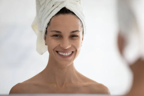 Miroir reflet de fille heureuse avec la tête enveloppée dans une serviette — Photo