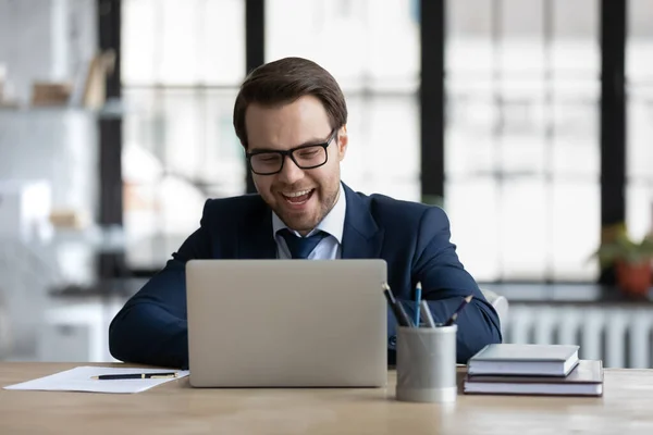 Happy excited financial broker, investor working at laptop — Stock Photo, Image