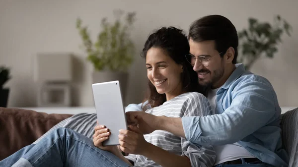 Smiling multiracial couple use tablet talk on webcam call — Stock Photo, Image