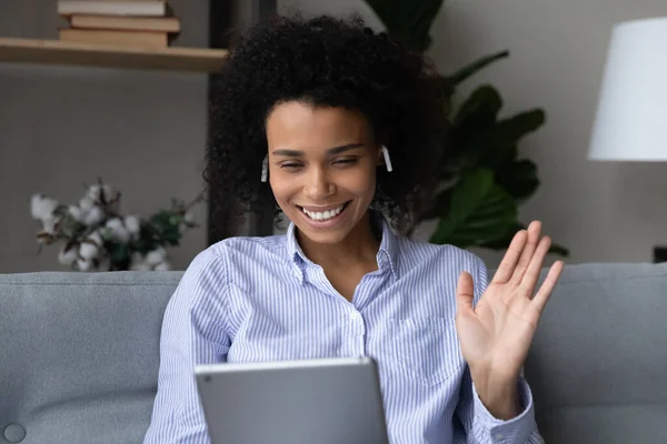 Smiling biracial woman wave talking on webcam call — Stock Photo, Image